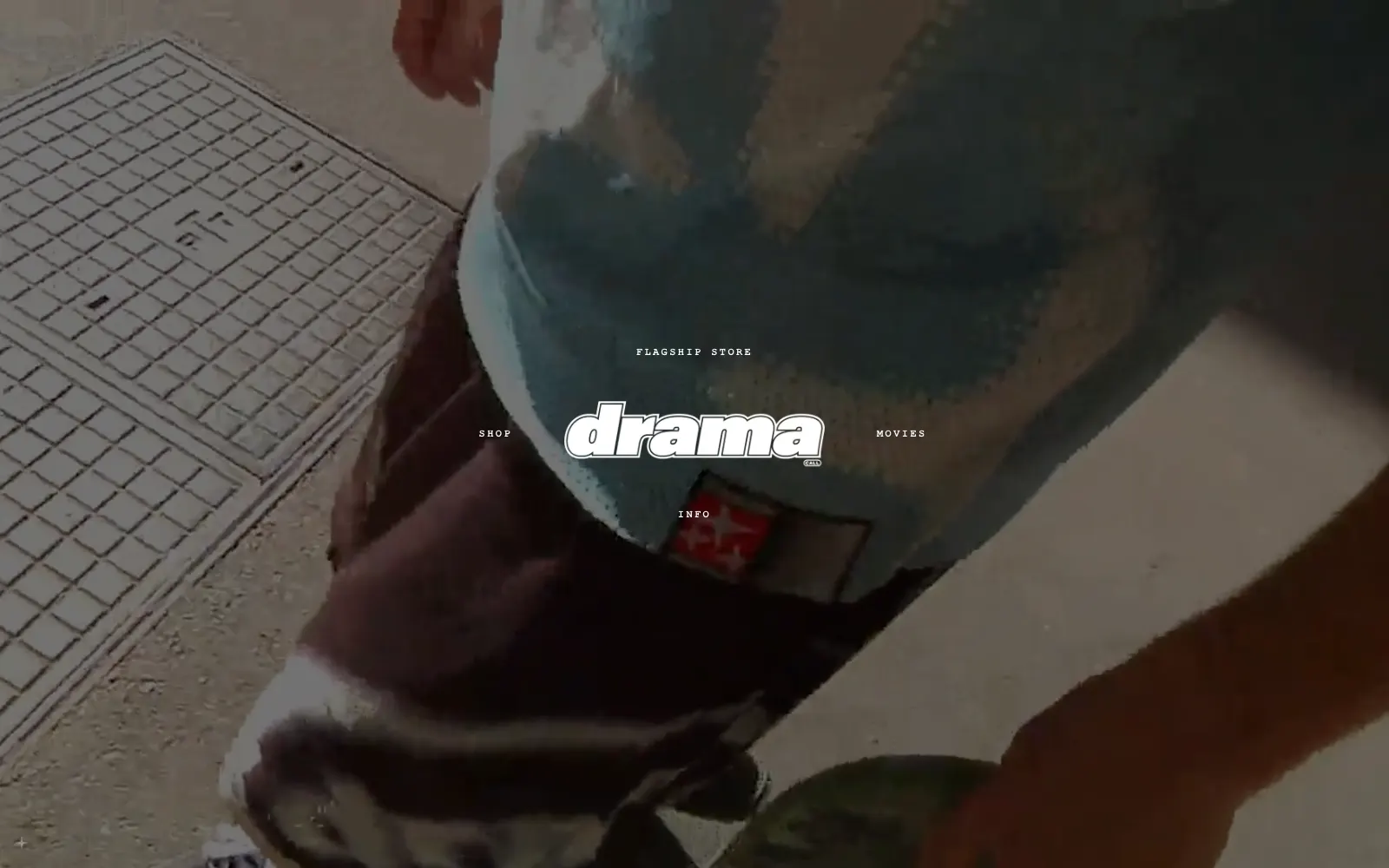 Drama Call landing page: the brand logo over a full-screen brand film, with links to the flagship store, shop, movies and info appearing around it
